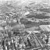 Oblique aerial view of centre of Edinburgh centred on St. Andrew's House, boiler house, and including St James' Centre and New Town at top of photograph, Royal High School to right, Cowgate at bottom and Waverley Station to left.