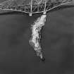 Oblique aerial view of The Forth Bridge and Inch Garvie centred on the rail bridge and the remains of a castle, battery, coast battery and artillery fortifications, taken from the E.