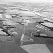 Oblique aerial view of East Fortune Airfield centred on the airfield, taken from the WNW.