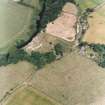 Oblique aerial view centred on the remains of the castle and garden with cottage and smithy adjacent, taken from the SW.