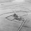 Oblique aerial view centred on the remains of the farmhouse, farmsteading and walled garden with the remains of the Norse houses adjacent, taken from the ESE