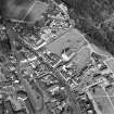 Oblique aerial view of Lesmahagow centred on the church and churchyard, taken from the SW.