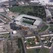 Glasgow, Parkhead, oblique aerial view, taken from the SSW, centred on Celtic Park football stadium, and showing the Eastern Necropolis graveyard in the centre right of the photograph.