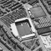 Oblique aerial view centred on the football stadium with jute works adjacent, taken from the NW.