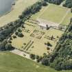 Oblique aerial view of Kinross House centred on the country house with garden and gate, taken from the E.