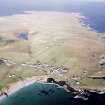 General oblique aerial view looking across the harbour, crofting township and lazy beds towards the townships and lighthouse, taken from the SE.