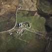 Oblique aerial view centred on the house, the farmsteading and the remains of the castle, taken from the NNW