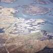 Oblique aerial view centred on the crofting township with the harbour, factory and school adjacent, taken from the SW.