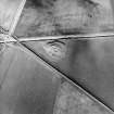 Oblique aerial view centred on the remains of the broch, taken from the SW.