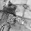 Oblique aerial view of the farmsteadings and country house, taken from the NE
