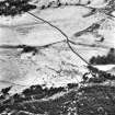 Ballourie, oblique aerial view, taken from the N, showing the remains of a township and rig in the left half of the photograph, and another township, buildings, banks and an enclosure in the right half.