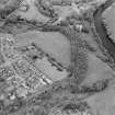 Oblique aerial view centred on the excavations of the Roman fort and possible annexe, with the adjacent castle, taken from the NW.