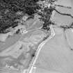 Oblique aerial view centred on the cropmarks of pits and linear cropmarks, with tower house, pits and walled garden adjacent, taken from the SW.