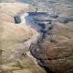 General oblique aerial view centred on the reservoir with quarry, farmsteads, enclosures, sheepfold and possible motte adjacent, taken during low water from the W.