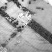 Oblique aerial view centred on the cropmarks of the ring-ditch with country house adjacent, taken from the NW.
