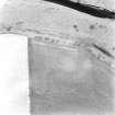Drumelzier Haugh, oblique aerial view taken from the SE, centred on the cropmarks of a ring ditch and possible souterrain.  A standing stone is also visible in the same field.