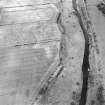 Oblique aerial view centred on the standing stone and the cropmarks of the ring-ditch and souterrain, taken from the NE.