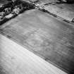 Oblique aerial view centred on the cropmarks of the enclosures with the country house adjacent, taken from the E.