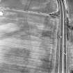 Newton, oblique aerial view, taken from the SW, centred on the cropmarks of two ring-ditches and further cropmarks. A pit-alignment is visible in the top centre of the photograph.