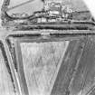 Oblique aerial view of Meadowmill centred on the cropmarks of an enclosure, taken from the NNW.