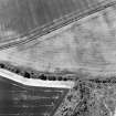 Oblique aerial view centred on the cropmarks of the possible enclosure, taken from the ENE.
