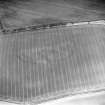 Oblique aerial view of Grizzlefield, East Rings centred on the cropmarks of a fort, taken from the WSW.