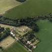 Oblique aerial view centred on the church and its burial-ground, gateway and walls, taken from the NE.