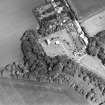 Oblique aerial view centred on the church and its burial-ground, gateway and walls, taken from the SW.