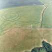 Oblique aerial view centred on the cropmarks of the field boundaries and cropmarks with fort adjacent, taken from the SW.