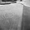 Oblique aerial view centred on the cropmarks of the fort with field boundaries and  cropmarks adjacent, taken from the ESE.
