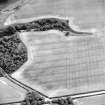 Oblique aerial view centred on the cropmarks of field boundaries with promontory fort adjacent, taken from the NE.