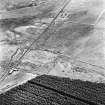 Pennymuir, oblique aerial view, taken from the NW, centred on three Roman Temporary Camps and an area of rig. The course of 'Dere Street' is shown in the left half of the photograph.