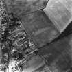 Oblique aerial view. General view of the village taken from the NE with a recorded site of cropmarks   (NT77SE 27) visible to the W.