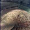 Oblique aerial view centred on the remains of the fort with the remains of the rig adjacent, taken from the ENE.