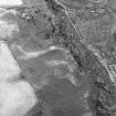 Leffnoll, oblique aerial view, taken from the NE, centred on the cropmarks of a possible settlement. A military camp is visible in the top right-hand corner of the photograph.