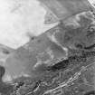 Leffnoll, oblique aerial view, taken from the NNE, centred on the cropmarks of a possible settlement. A military camp is visible in the bottom right-hand corner of the photograph.