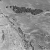 Oblique aerial photograph of Leffnoll taken from the W, centred on the cropmarks of a settlement with the remains of a military camp across the stream.
