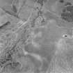 Oblique aerial photograph of Leffnoll taken from the SW, centred on the cropmarks of a settlement with the remains of a military camp across the stream.