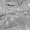 Oblique aerial photograph of Leffnoll taken from the S, centred on the cropmarks of a settlement with the remains of a military camp across the stream.