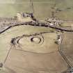 Oblique aerial view centred on the remains of the motte-and-bailey castle, taken from the WSW.