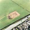 Oblique aerial view of Holywood centred on the excavation of a cursus and ring-ditch, taken from the ESE.
