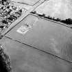 Oblique aerial view of Holywood centred on the excavation of a cursus and ring-ditch, taken from the NW.