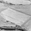 Oblique aerial view centred on the cropmarks of the Roman Temporary Camp and pit-defined cursus, taken from the SSE.