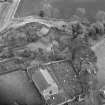 Oblique aerial view of Barton Hill motte under excavation and Kinnaird Parish Church and churchyard.