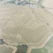 Oblique aerial view centred on the cropmarks of an enclosure with pits, a possible enclosure and possible pit-defined enclosure adjacent, taken from the ESE.