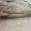 Detail of junction of slab floor of cistern and side walls showing bones and smears of charcoal.