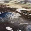 Oblique aerial view of White Caterthun centred on the remains of a fort, taken from the WNW.