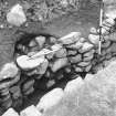 Excavation photograph : Alcove in SW wall of souterrain, with blocking.