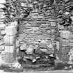 Excavation photograph : back of fireplace showing recently consolidated masonry overlying loose rubble and soils, from S. (E range)