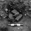 Excavation photograph : trench V - feature EDG, post packing, partial ex.